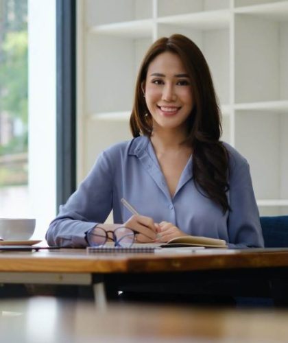 Photo of gorgeous secretary working at office. she sitting at the wooden desk